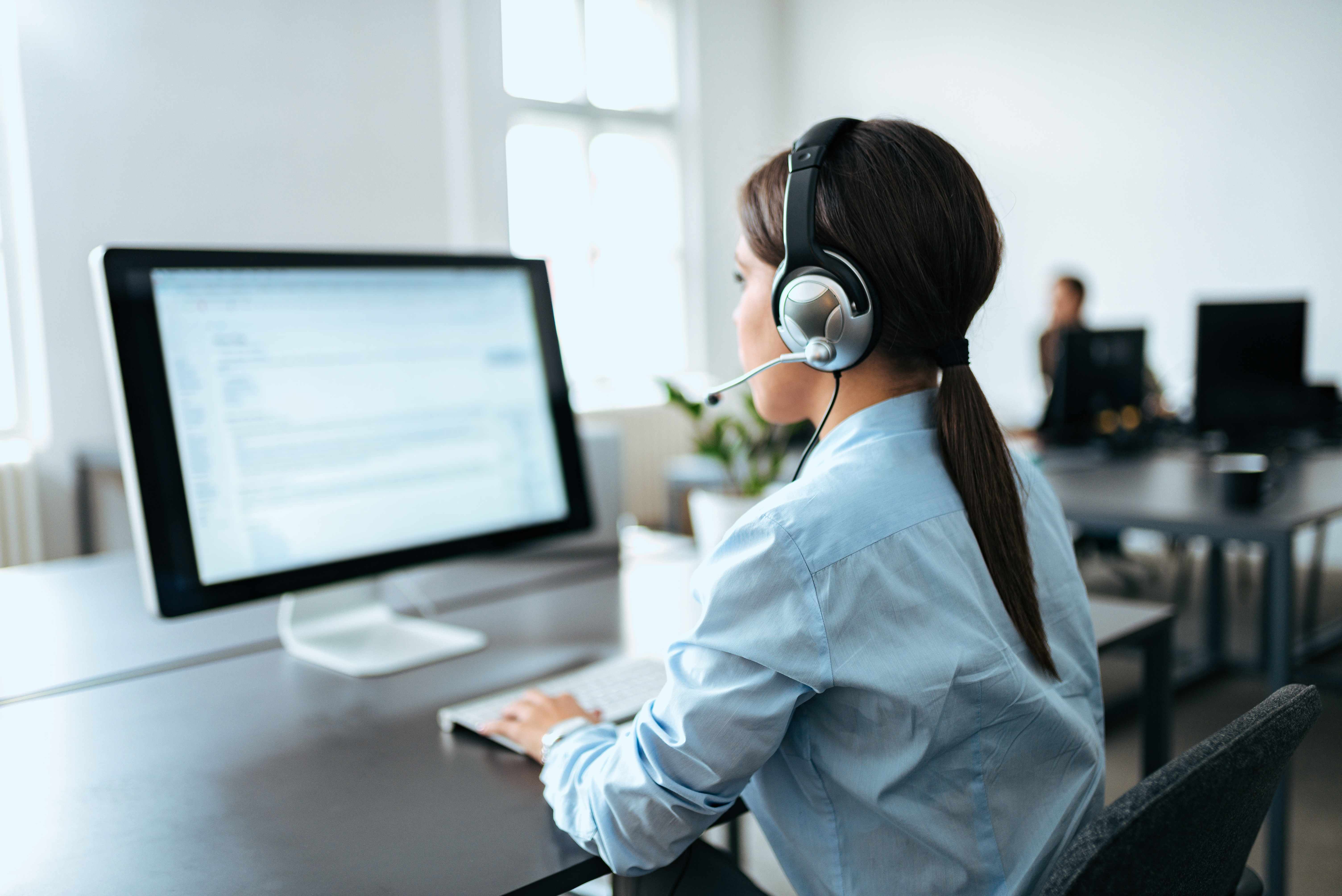 Female customer service representative with headset working